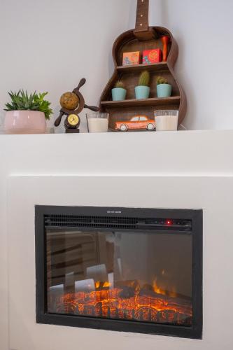 a fireplace in a living room with a fire place at Remvi GUEST HOUSE in Pramanta
