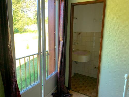 a bathroom with a shower and a sink next to a window at LE CANTEGREL in Teillet