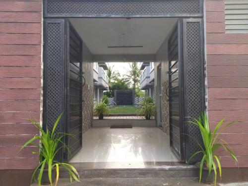 an open hallway of a house with plants at La Villa Beach Paradise in Mahabalipuram
