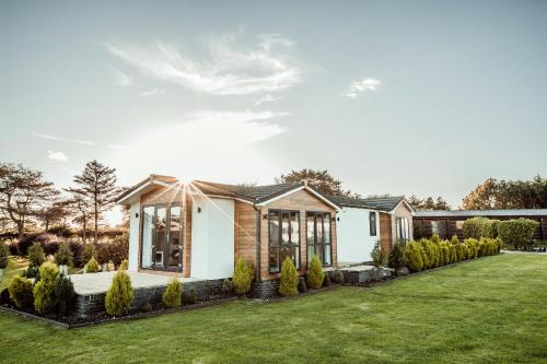 a house with a garden in front of it at Little Eden Country Park, Bridlington with Private Hot Tubs in Bridlington