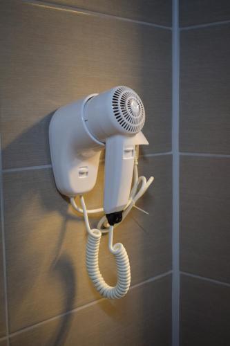 a blow dryer is attached to a wall at Garni hotel Mali predah - novi deo in Knjazevac.