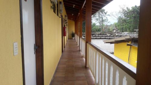an empty corridor of a building with a balcony at Camping Pousada Ilha do Mel - Frente ao Mar in Boracéia