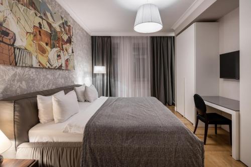 a hotel room with a bed and a desk at Cityhotel Apartments in Kyiv