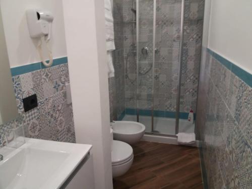 a bathroom with a toilet and a shower and a sink at Pigneto Square Home in Rome