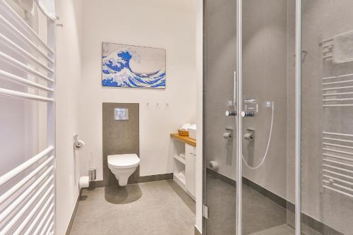 a bathroom with a toilet and a glass shower at Magnolia in Ostseebad Sellin
