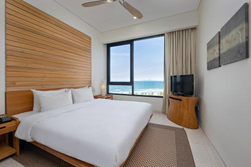 Postel nebo postele na pokoji v ubytování Abogo Apartment Resort Beach Da Nang