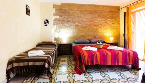 a hotel room with two beds in a room at Studio with city view balcony and wifi at Castelbuono in Castelbuono