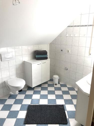 a bathroom with a toilet and a sink at Gästehaus-Après-Park in Rust