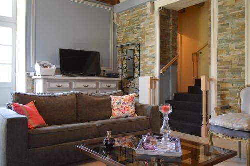 a living room with a couch and a table at Villa Moncoeur in Le Blanc