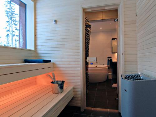 a bathroom with a tub and a sink and a toilet at Ottsjö Bear Lodge in Ottsjö