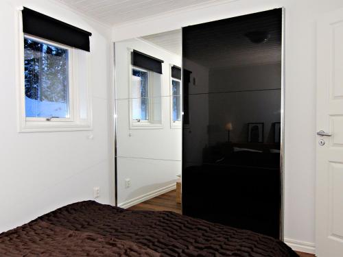 a bedroom with a bed and a window at Ottsjö Bear Lodge in Ottsjö