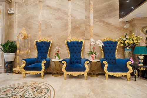a group of four blue chairs and a table at Athena Hotel Quy Nhơn in Quy Nhon