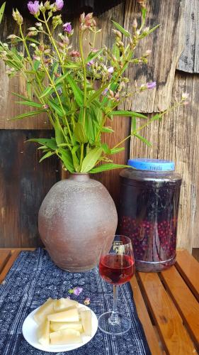 a vase with a plant and a glass of wine at Tavan View Homestay in Sa Pa