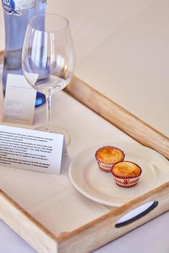 a plate of muffins and a glass of wine at Silken Gran hotel Durango in Durango