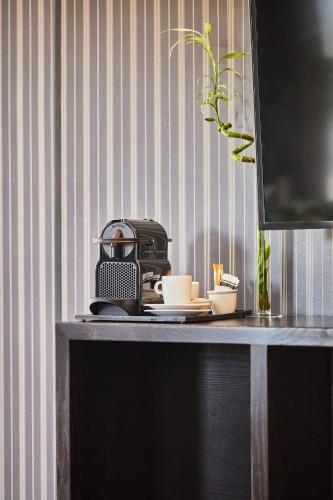 a table with a toaster and cups on it at Silken Gran hotel Durango in Durango