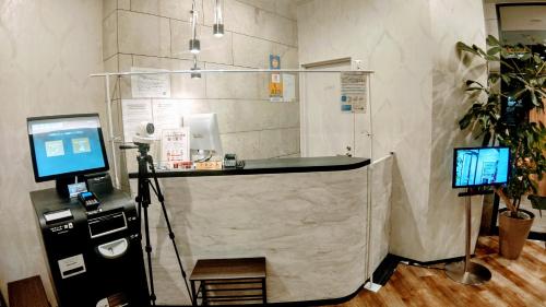 a room with a desk with two computers in it at Hotel Classe Stay Sapporo in Sapporo