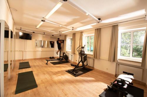 a gym with treadmills and exercise bikes in a room at Landhotel Kauzenberg in Bad Kreuznach