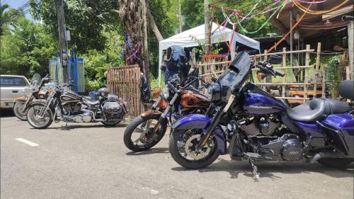 a group of motorcycles parked in a parking lot at Pano Solar Guest House (พาโน โซล่า เกสเฮ้าส์ ) in Trat