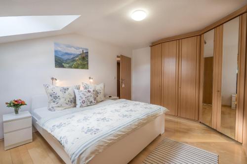 1 dormitorio con 1 cama blanca grande y armarios de madera en Oberstdorfer Bergwelt 320, en Oberstdorf