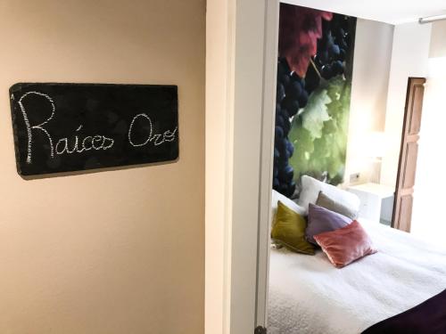 a bedroom with a bed with colorful pillows at La Casona de Alútiz & Bodega in Samaniego