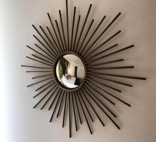 a large black starburst mirror on a wall at La Casona de Alútiz & Bodega in Samaniego