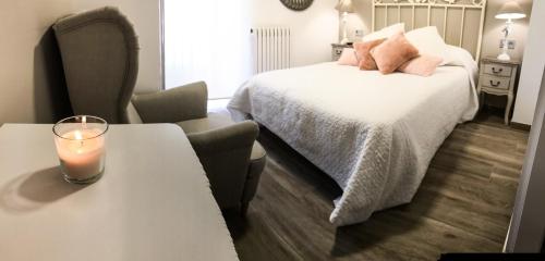 a bedroom with a bed and a candle on a table at La Casona de Alútiz & Bodega in Samaniego
