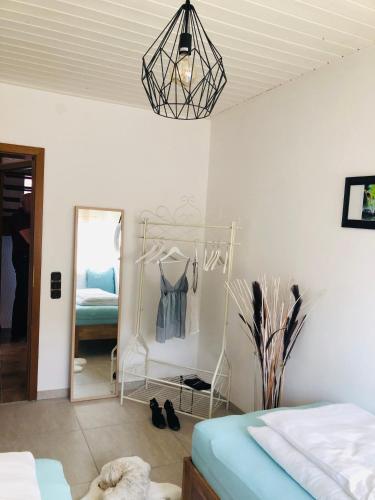 a bedroom with a bed and a mirror and a room with a mirror at Idyllische Ferienwohnungen in Mossendorf in Burglengenfeld