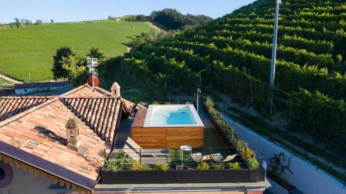 an overhead view of a house with a swimming pool and a vineyard at Villa Giobatta in Barolo