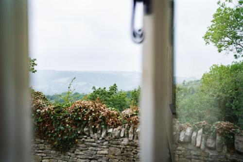 a view of a stone wall from a window at The Bear Of Rodborough Hotel in Stroud