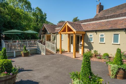 a house with a white fence and a driveway at The Water Rat in Ironbridge