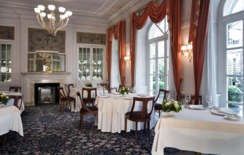a dining room with tables and chairs and a fireplace at Grand Hotel Sitea in Turin