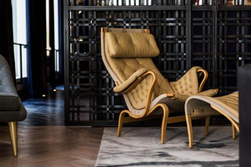 a pair of chairs in a room with a wall of wine racks at Kimpton Gray Hotel Chicago by IHG in Chicago