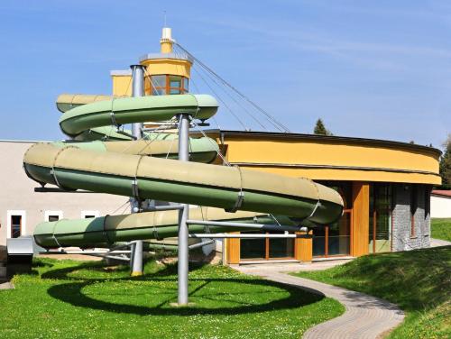 a water slide in front of a building at Hotel VZ Měřín in Merin