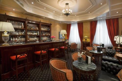 a bar in a restaurant with tables and chairs at Grand Hotel Sitea in Turin