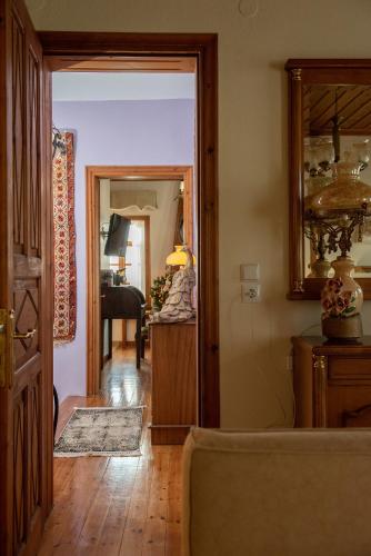 a room with a hallway with a mirror and a living room at Dandy Villas Nymfaio - Snow Fairy - Sauna in Nimfaíon