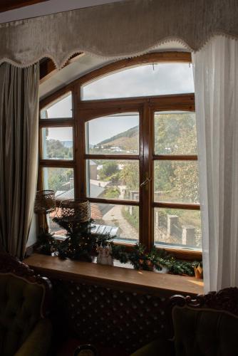 a window with christmas decorations on a table at Dandy Villas Nymfaio - Snow Fairy - Sauna in Nimfaíon