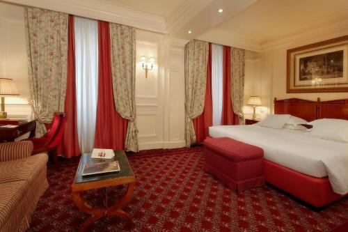 a hotel room with a bed and a couch at Grand Hotel Sitea in Turin