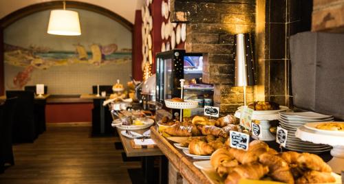 a buffet line with bread and pastries on at Hotel Casali in Cesena