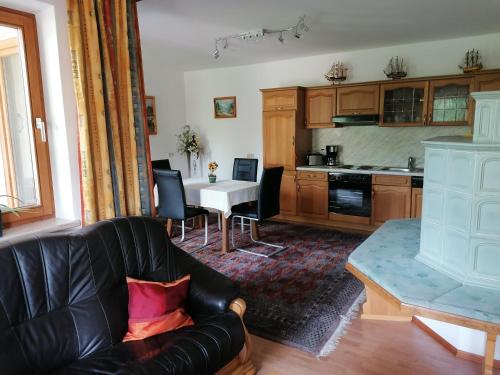 a living room with a couch and a table at Heilbad Burgwies in Stuhlfelden