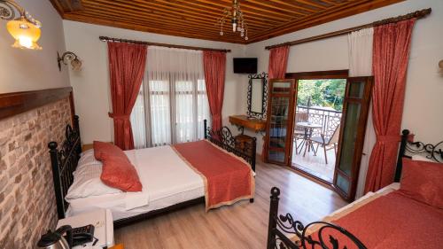 a bedroom with a bed and a balcony at Antalya Inn Hotel in Antalya