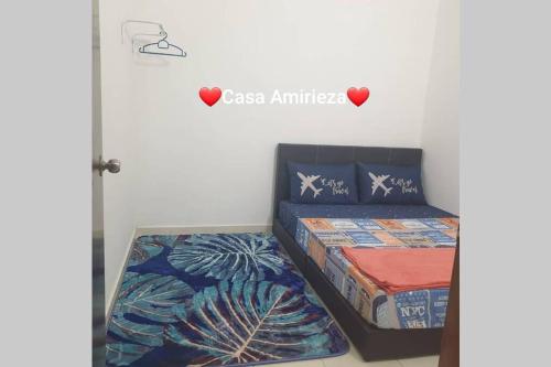 a bedroom with two beds and a sign that reads casa aminez at Casa Amirieza in Port Dickson
