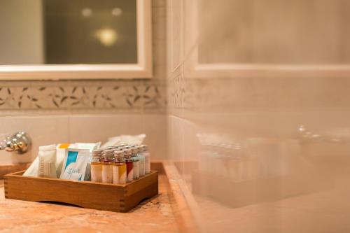 a tray of toothpaste and toothbrushes on a bathroom counter at Hotel Casali in Cesena