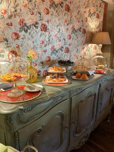 a blue buffet with plates of food on it at Maison Otto in Bossolasco