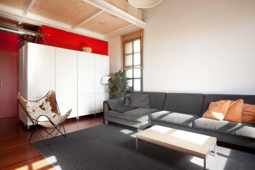 a living room with a couch and a table at Beach Loft Duplex in Barcelona