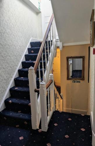 a staircase in a building with blue stairs at The Sycamore Guest House in York