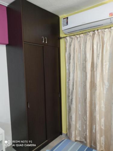 a wardrobe in a room with a curtain at G M 2 ROOMS KENTRO in the heart of the city in Larisa