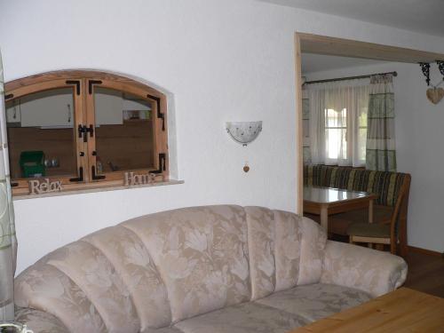 a living room with a couch and a table at Gästehaus Gaisalpe in Fischen