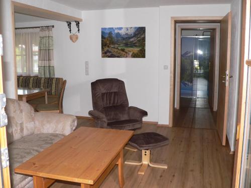 a living room with a wooden table and chairs at Gästehaus Gaisalpe in Fischen
