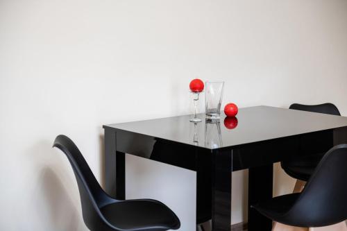 a black and white table with red balls on top of it at Центр міста! Затишні квартири в новобудові! in Uzhhorod