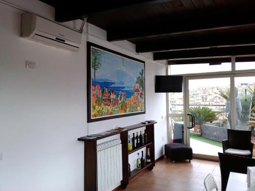 a living room with a large painting on the wall at B&B Panoramic in Valguarnera Caropepe